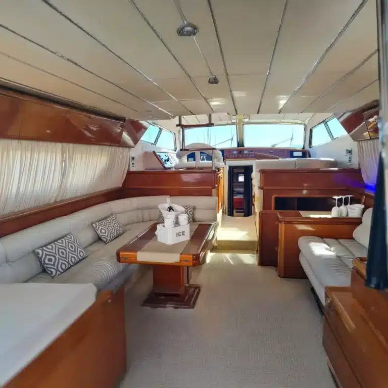 Luxurious yacht interior with wood paneling, plush seating, and warm ambiance, ideal for comfort and style while cruising.