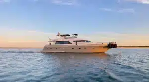 Luxury yacht Katerina XL anchored during sunrise at Cascais Marina, with calm waters and clear sky, offering a peaceful boating experience.