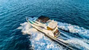 KEV motor yacht cruising with speed on calm, sunny open sea near Marina de Vilamoura.